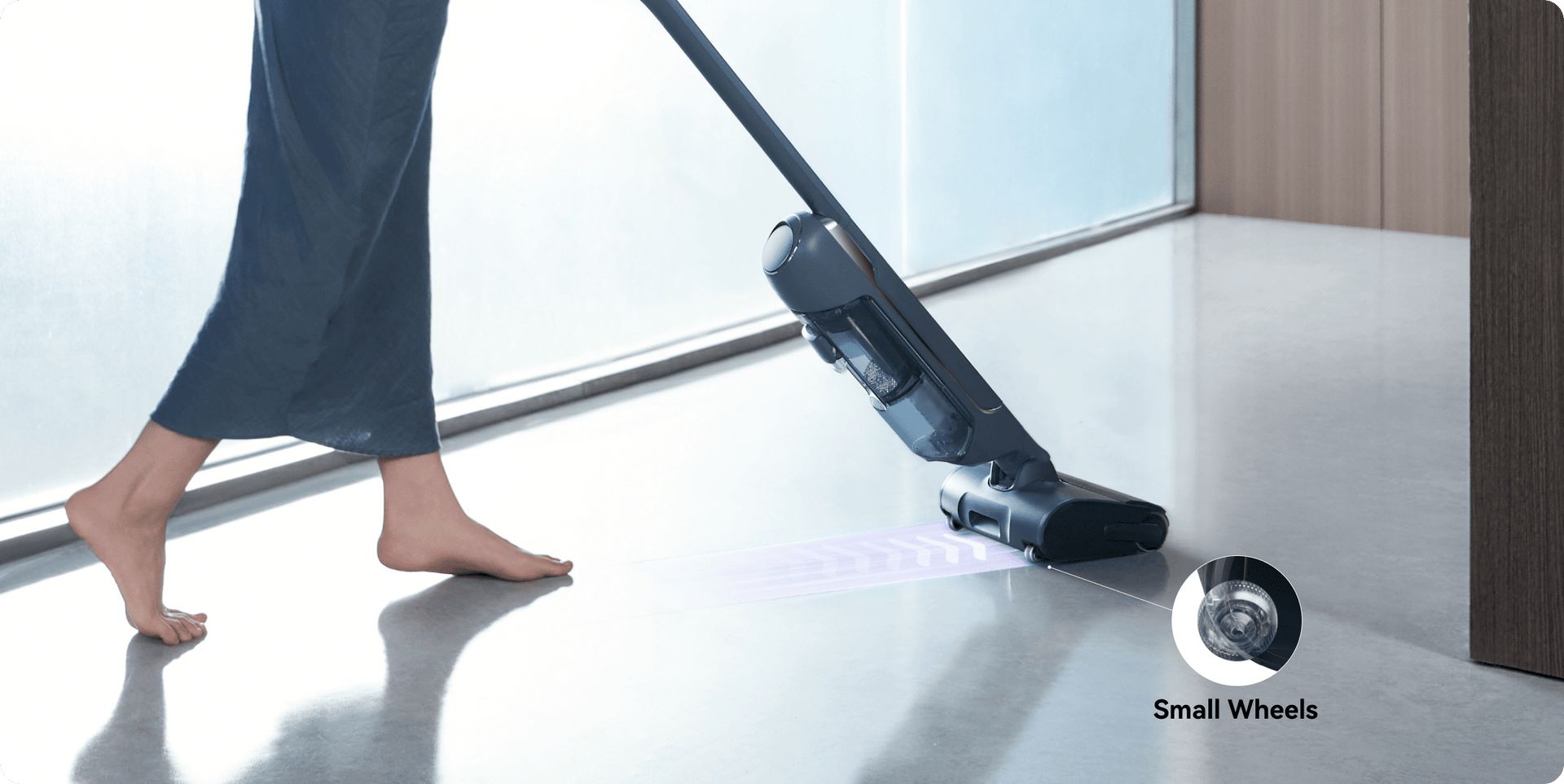 The person is using the Narwal s20 pro vacuum mop with small wheels.