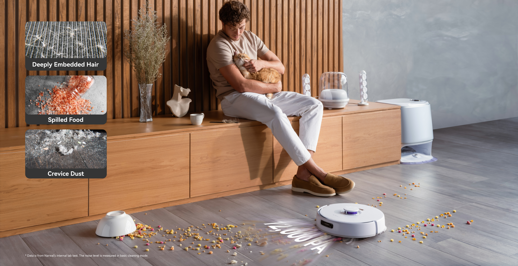 Narwal freo z ultra robot vacuum cleaning deeply embedded hair, spilled food, and crevice dust while a person enjoys time with their cat.