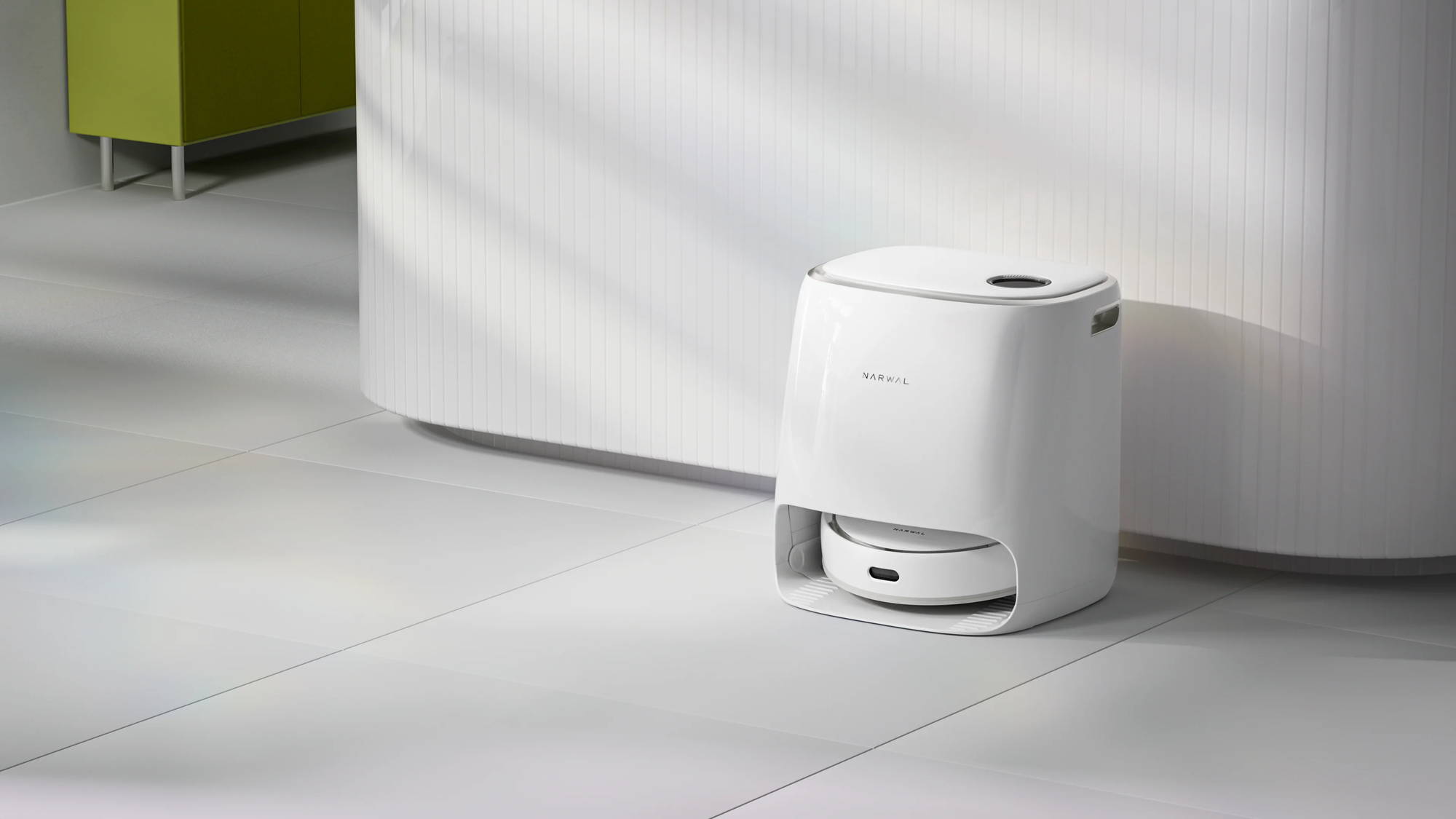 Narwal Freo Versatile Self Mop Clean Robot resting in its base station, with the sleek white base station visible in the background.