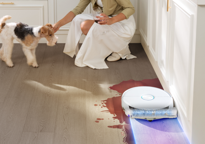 Narwal R32 mopping a kitchen floor along baseboards