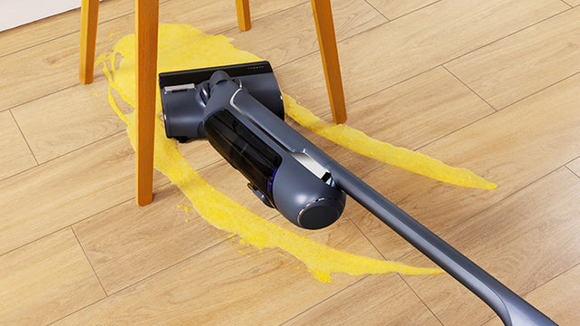 Narwal S20 Pro cordless vacuum mop cleaning spilled yellow liquid from the floor, effectively handling wet messes.