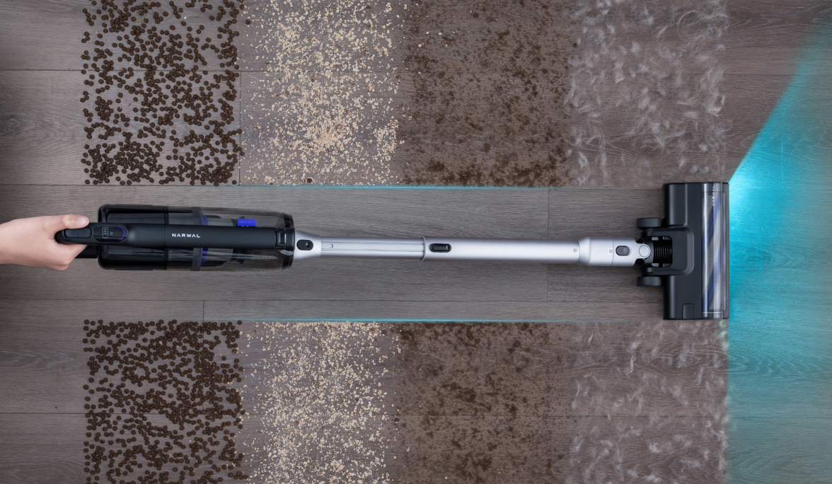 Overhead view of the Narwal V50 Cube cleaning debris from a rug