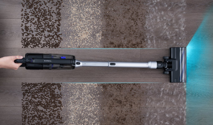 Overhead view of the Narwal V50 Cube cleaning debris from a rug