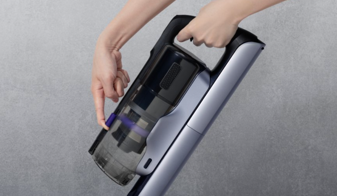 Person operating the Narwal V50 Cube dust cup scraping mechanism