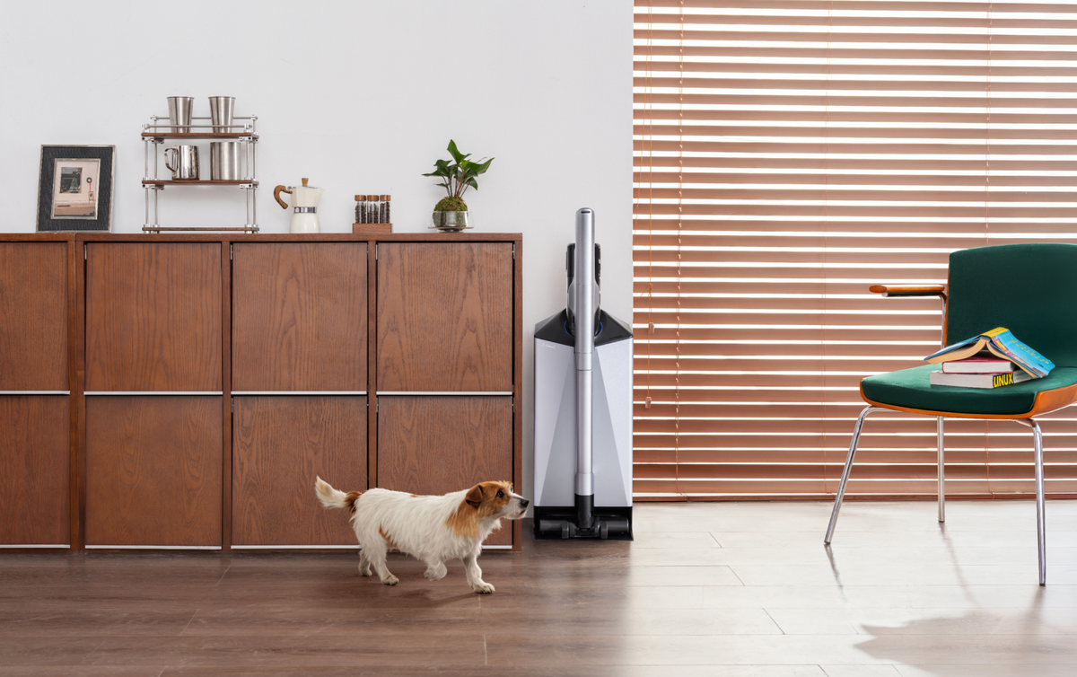Narwal V50 Cube station beside a wooden cabinet and a dog