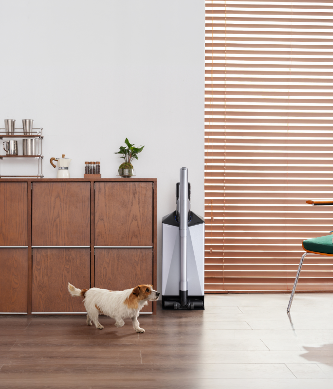 Narwal V50 Cube station beside a wooden cabinet and a dog