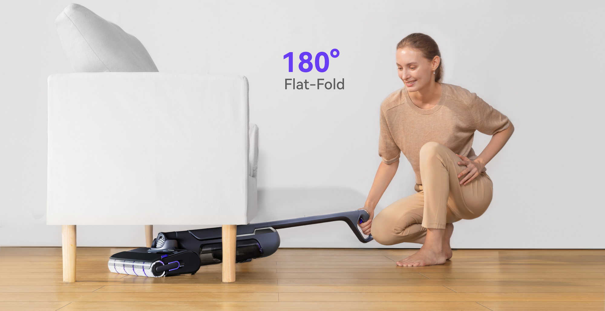 Narwal S20 Pro Vacuum Mop with 180° flat-fold feature, shown being used under a low sofa by a person for easy maneuvering.