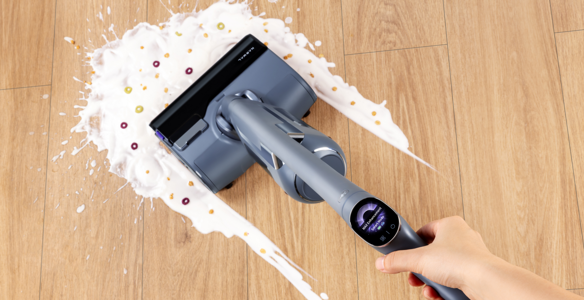Narwal S20 Pro Vacuum Mop in action, cleaning a spill of milk and cereal with the display showing a real-time update of cleaning status.